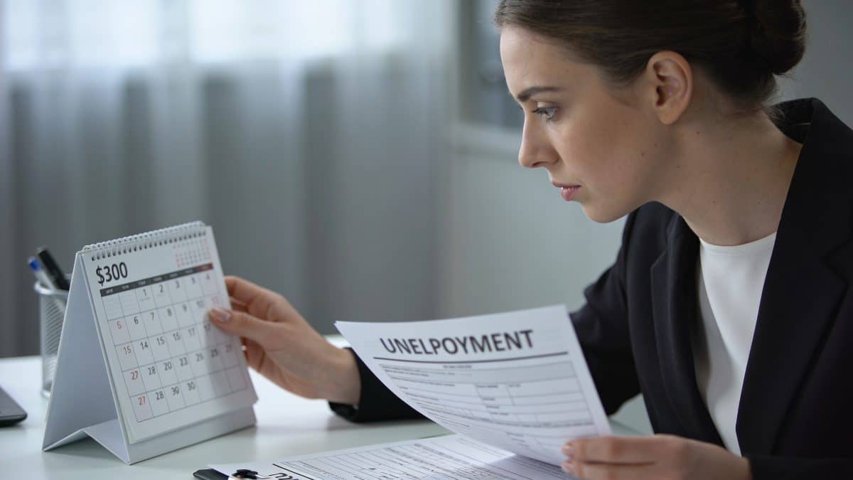 Femme au bureau consulte calendrier et formulaires chomage