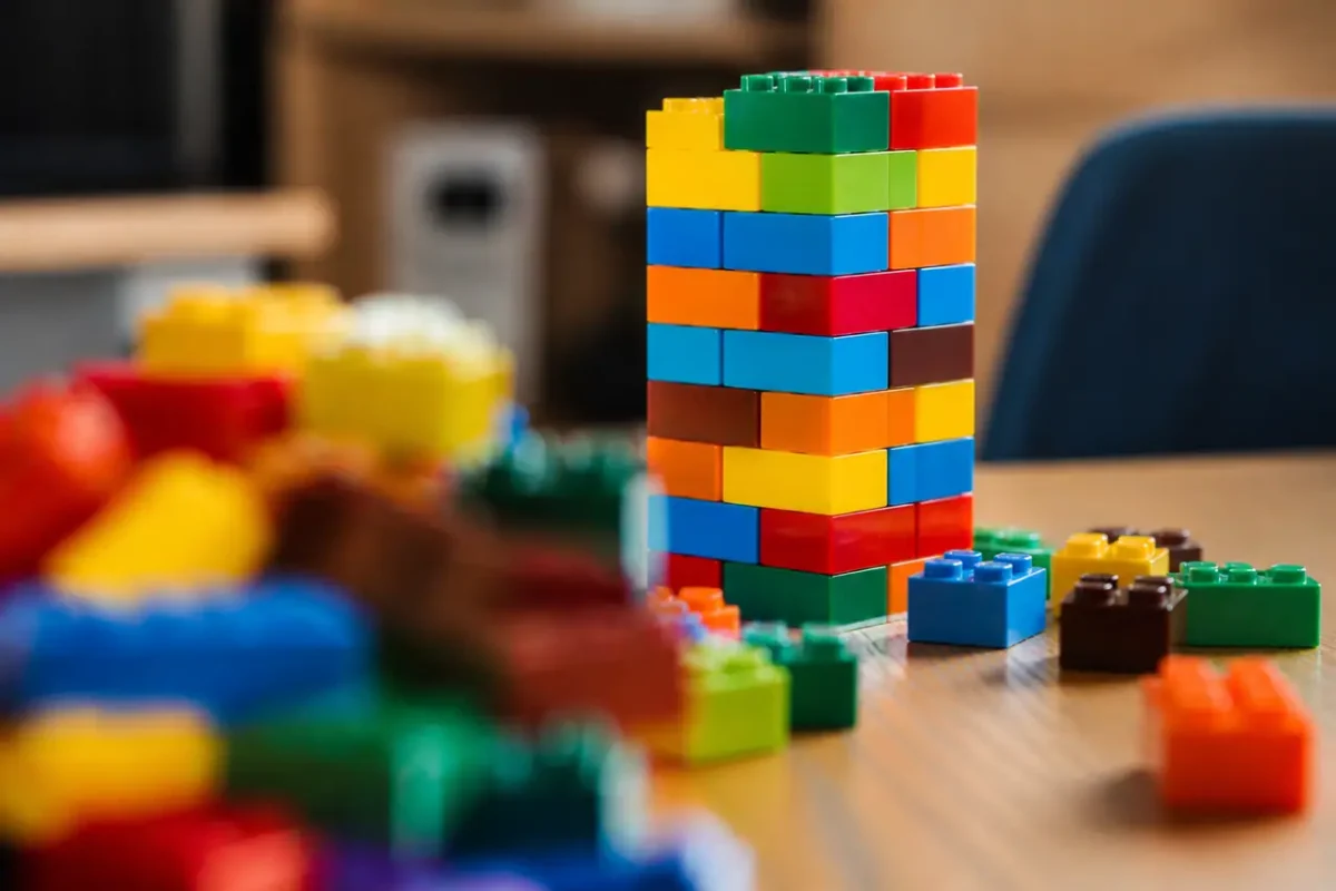 Briques Lego colorees empilees sur une table en bois