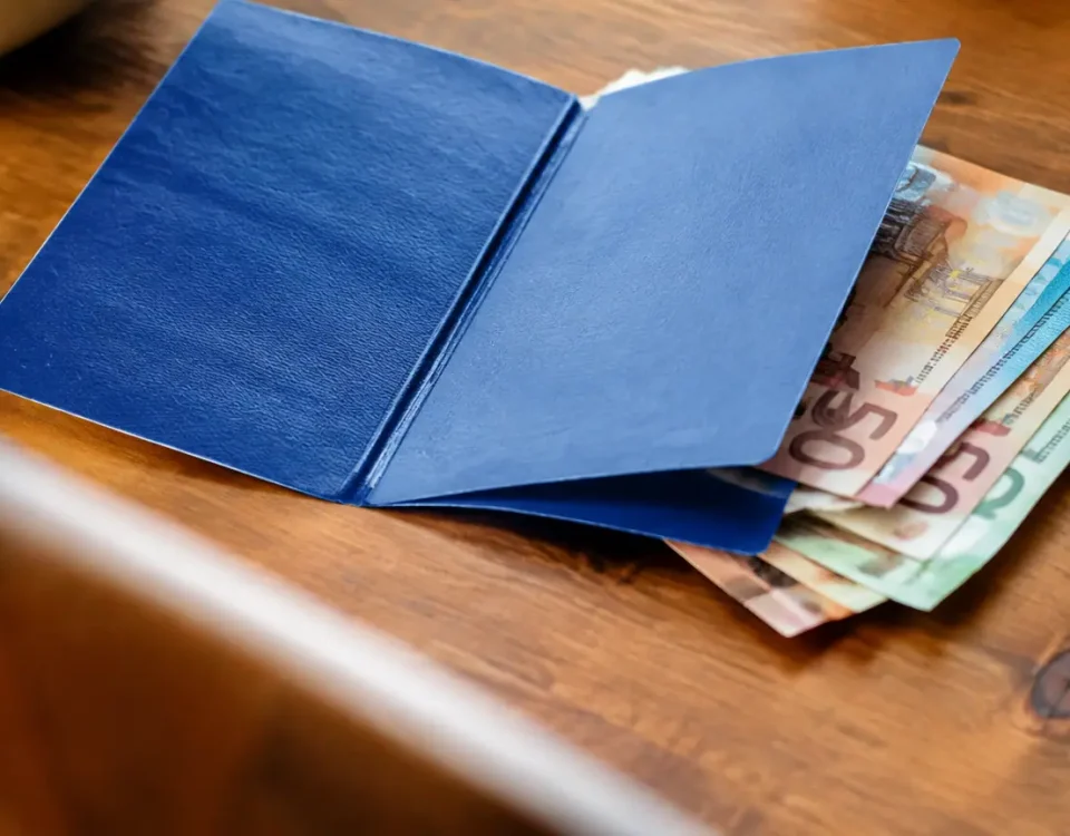 Carnet bleu ouvert sur une pile de billets